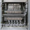 Grey multicore signal cables routed to terminal strips in an electronics rack