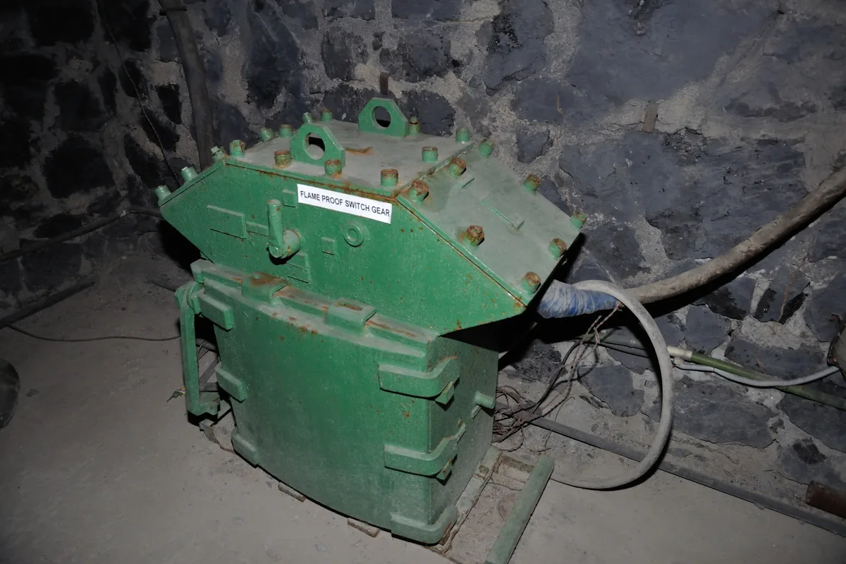 Green flameproof switchgear with bolted covers and a cable entry in a coal mine roadway display, the kind of equipment an MGM 109 Type 3123 screened armoured cable feeds
