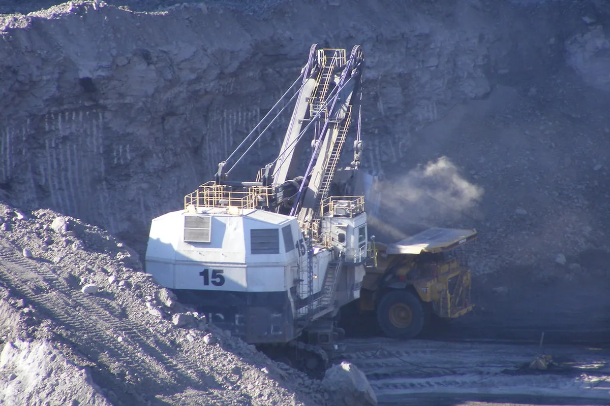 Electric rope shovel loading a haul truck at a surface coal mine, an excavating machine class supplied through 3.3 kV screened cables such as MGM 111 Type 320 or 321