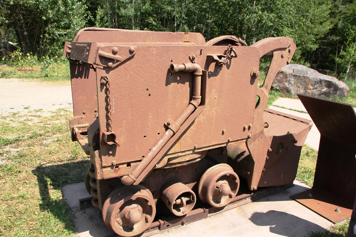 Rail-mounted underground mucking loader on display at the Soudan Underground Mine, a mobile machine class supplied through flexible trailing cables such as MGM 115 Type 11