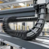 Grey polyurethane control cables running in a cable drag chain Grey polyurethane control cables running in a cable drag chain