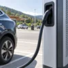 Flexible charging cable on a DC fast charger at a highway service area Flexible charging cable on a DC fast charger at a highway service area