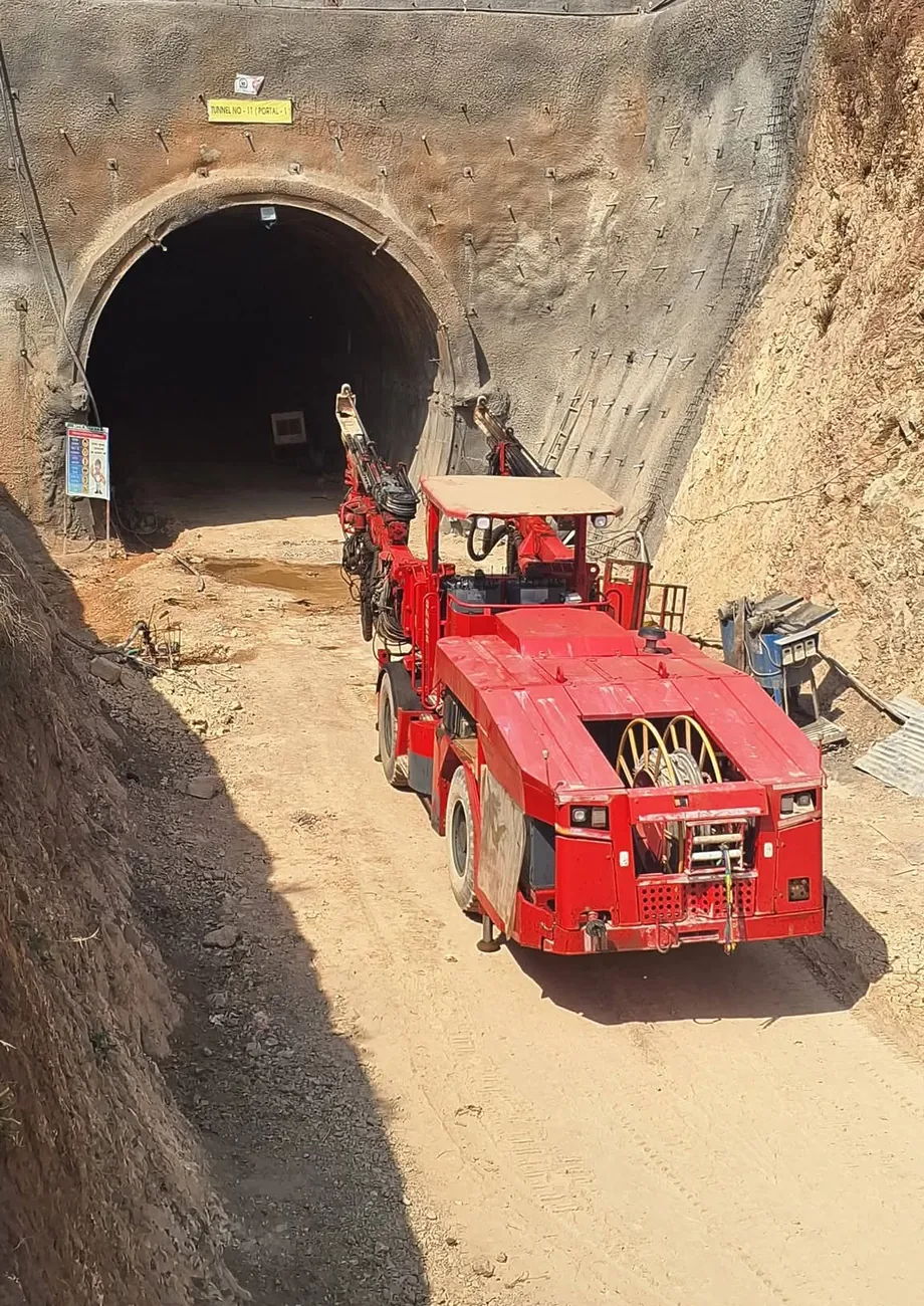 Red mining truck at a tunnel portal