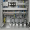 Grey control cables entering an industrial control cabinet through cable glands