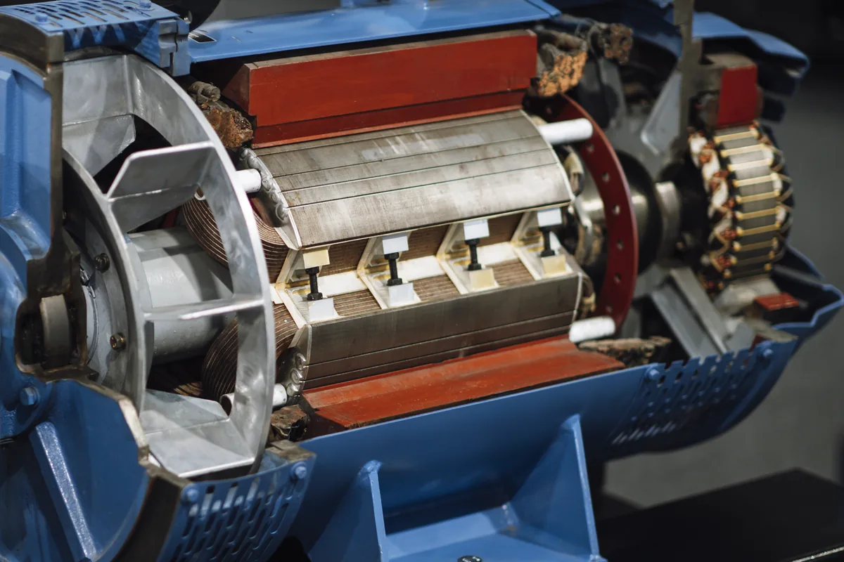 Cutaway industrial electric motor showing the stator windings and rotor, the kind of electrical machine whose internal leads use 200 °C PTFE wire such as UL 1199