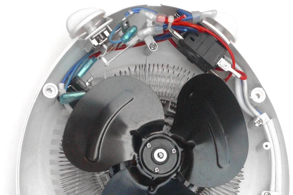 Opened fan heater showing the fan, heating coil, thermostat, switches and internal wiring, the kind of totally enclosed appliance wired with 150 °C silicone rubber wire such as UL 3132